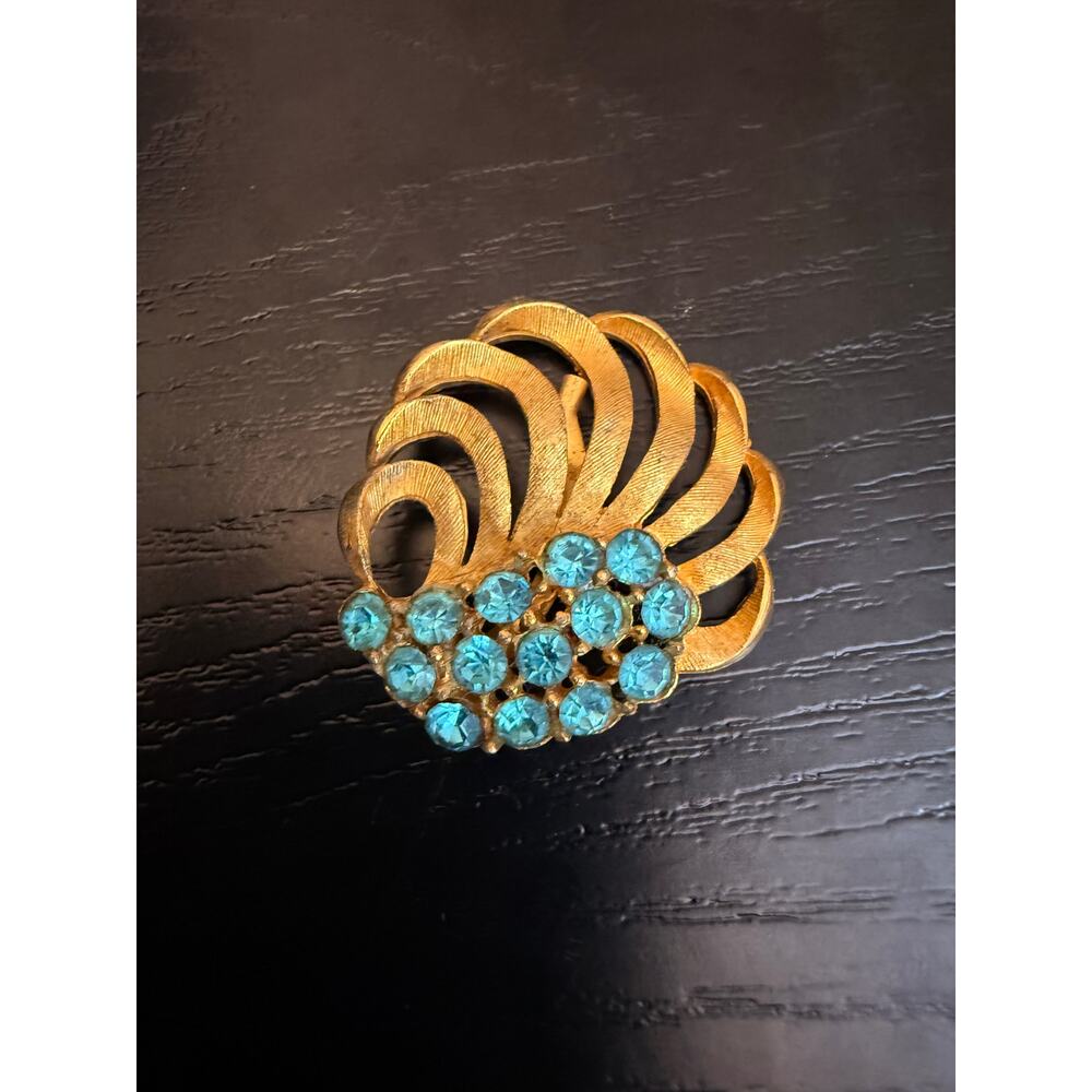 Vintage Gold Tone Blue Rhinestone Swirl Brooch